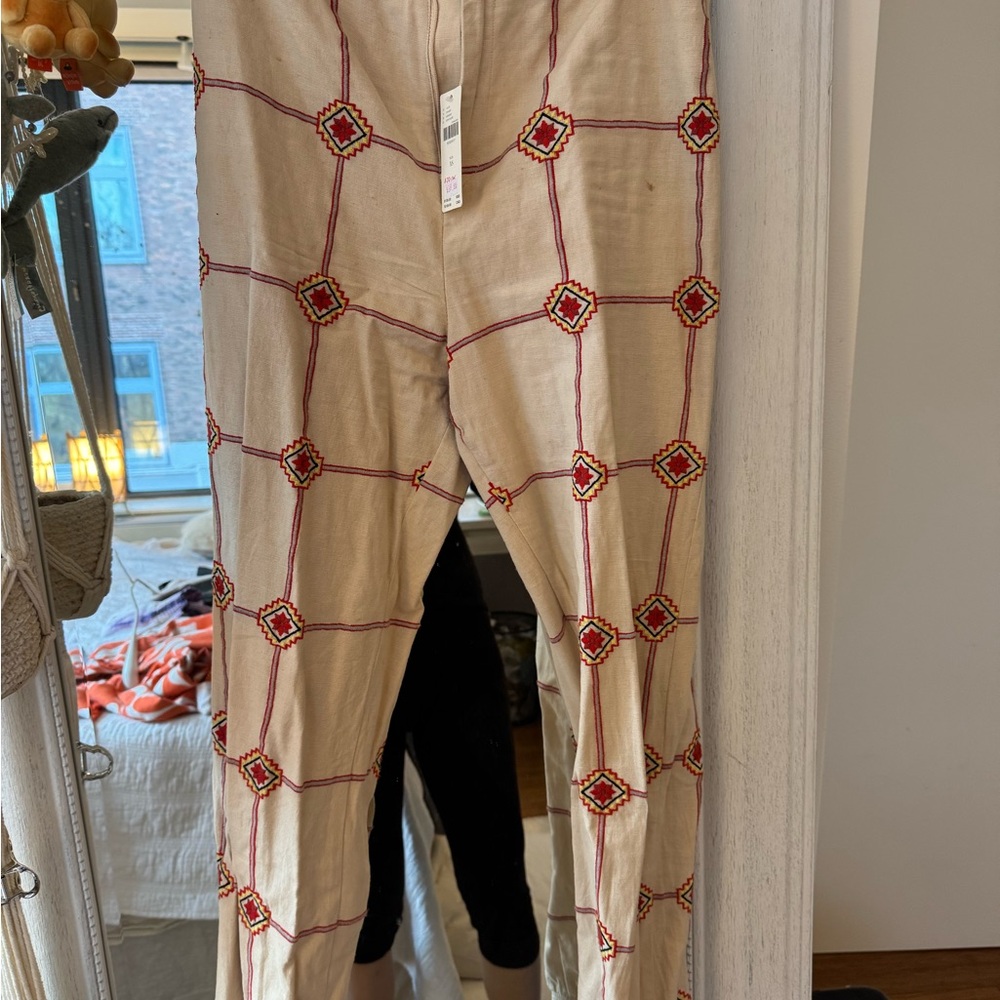 Anthropologie Beige Pants with Red and Yellow Embroidered Aztec Grid